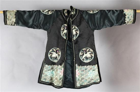 A Chinese black satin crane medallion jacket, early 20th century, replacements to sleeves